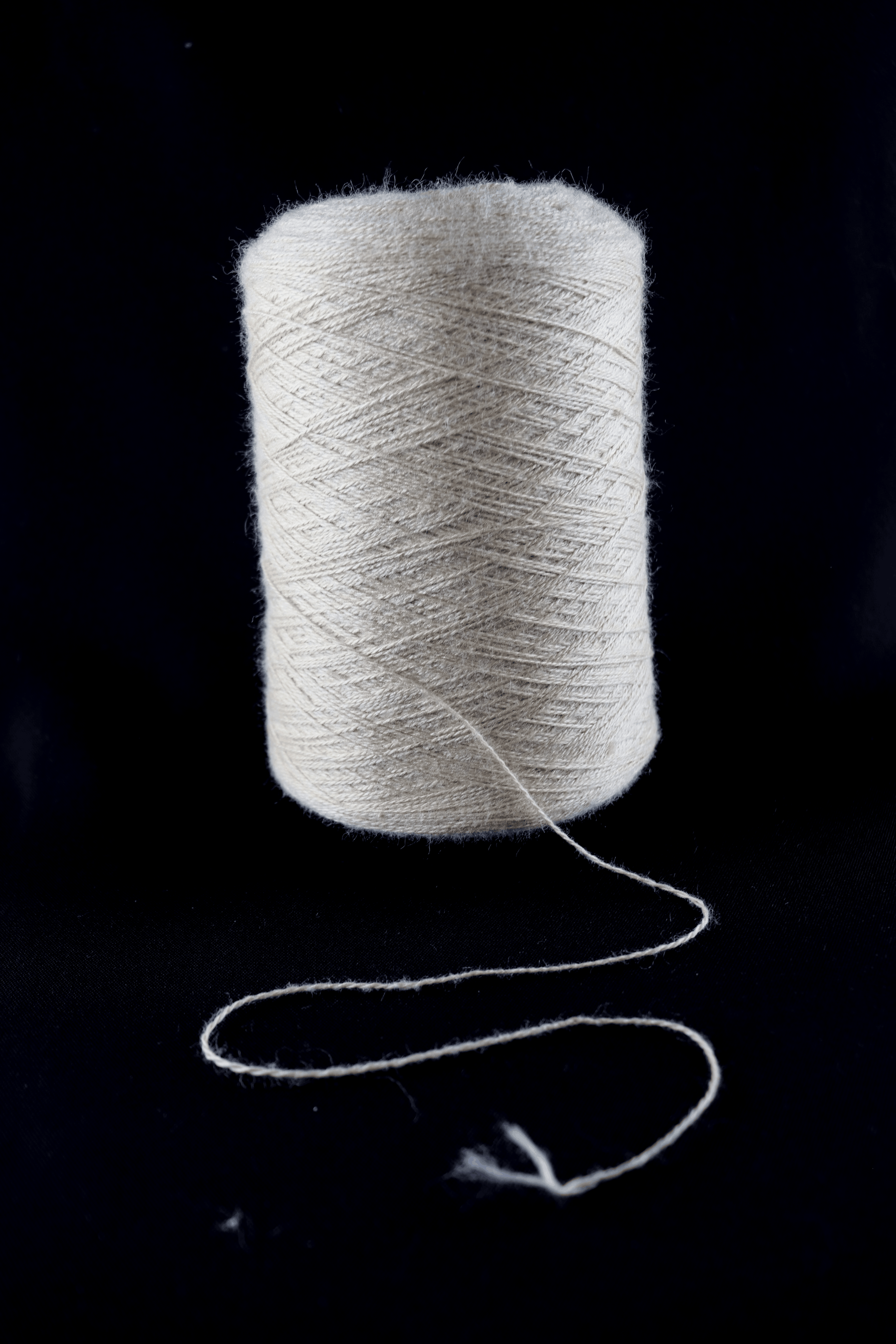 cone of white yarn