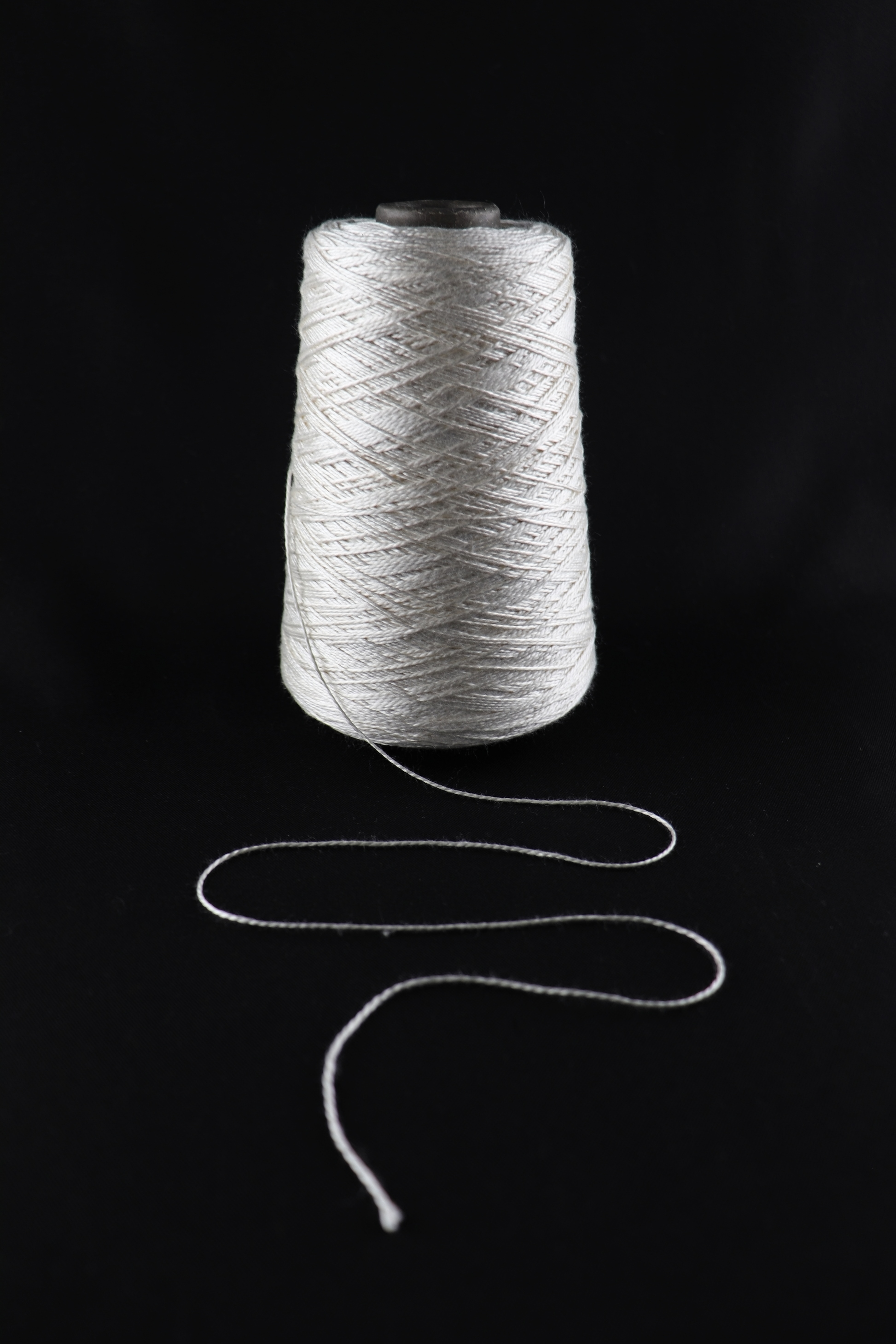 cone of white yarn