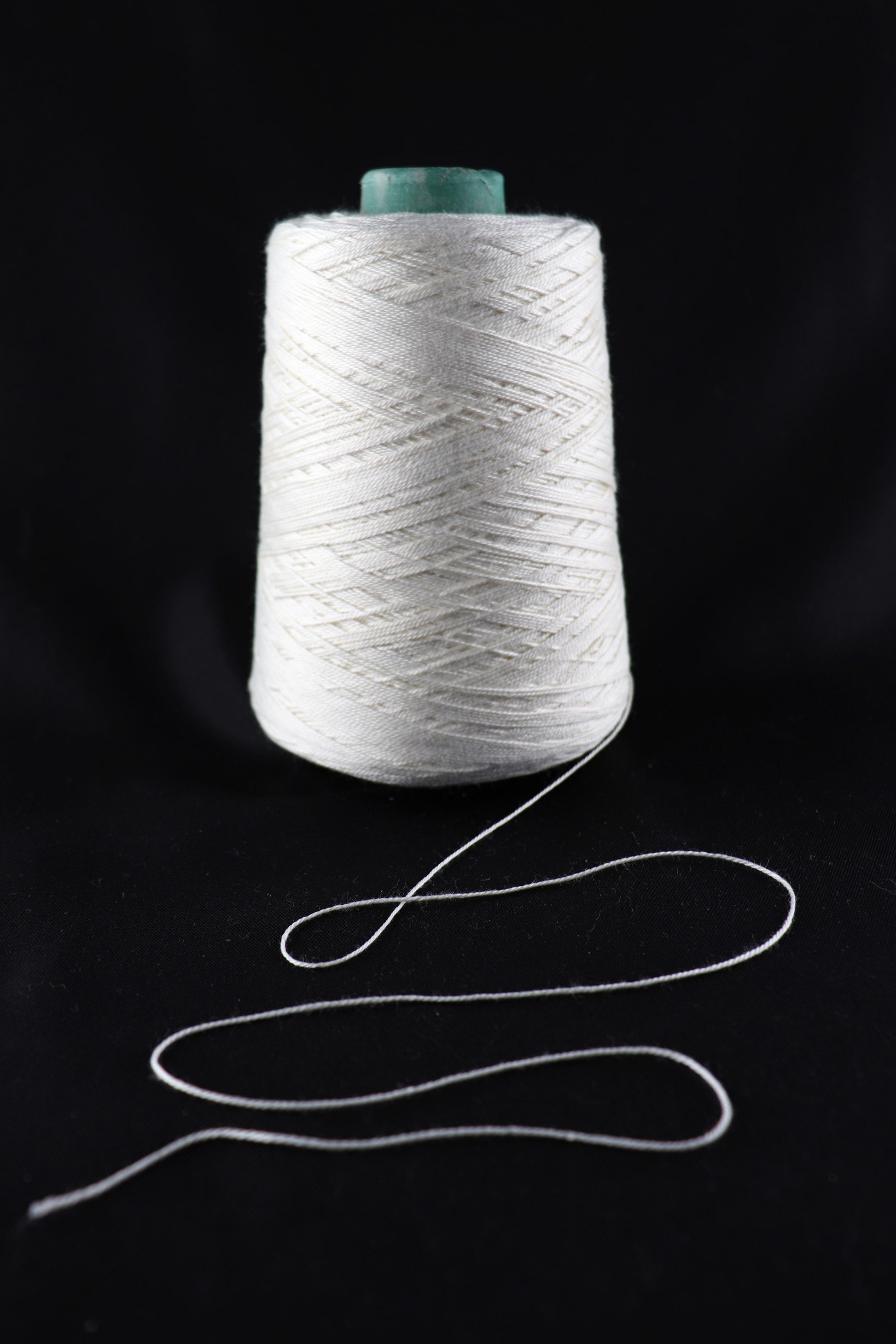 cone of white yarn