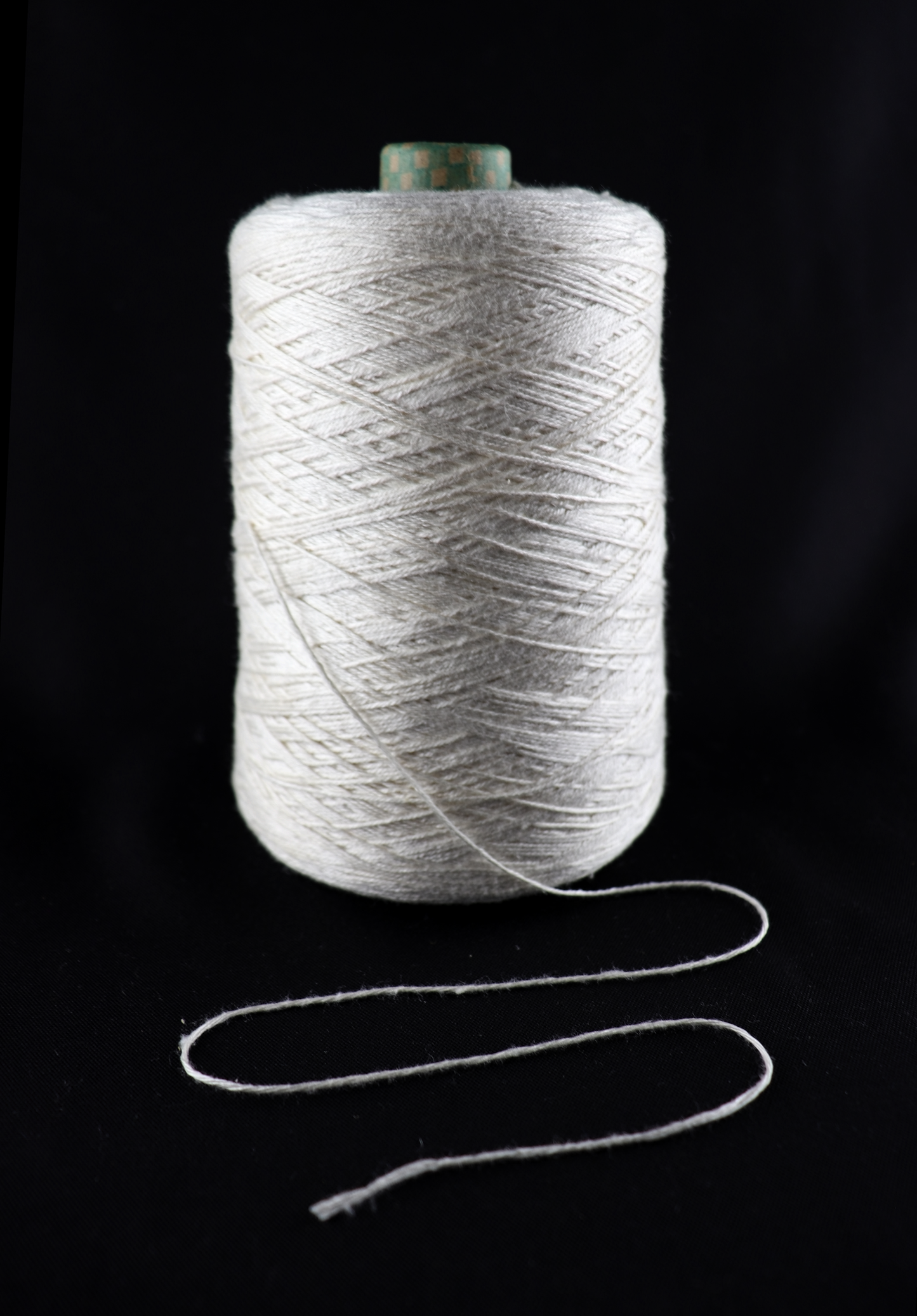 cone of white yarn