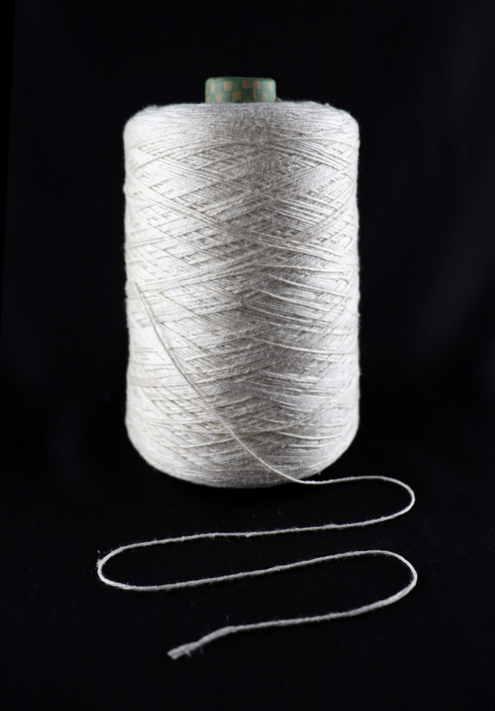 cone of white yarn