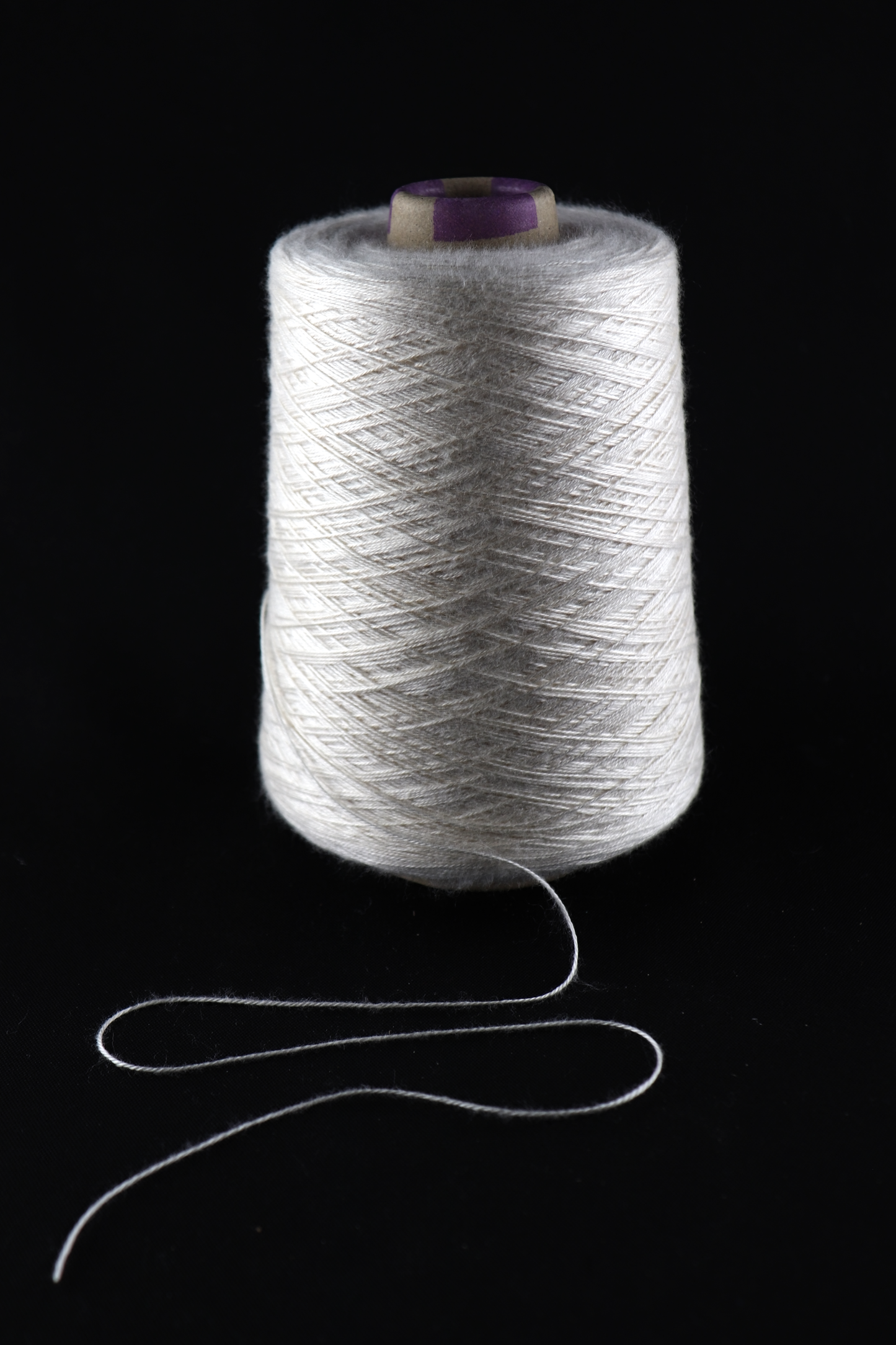 cone of white yarn