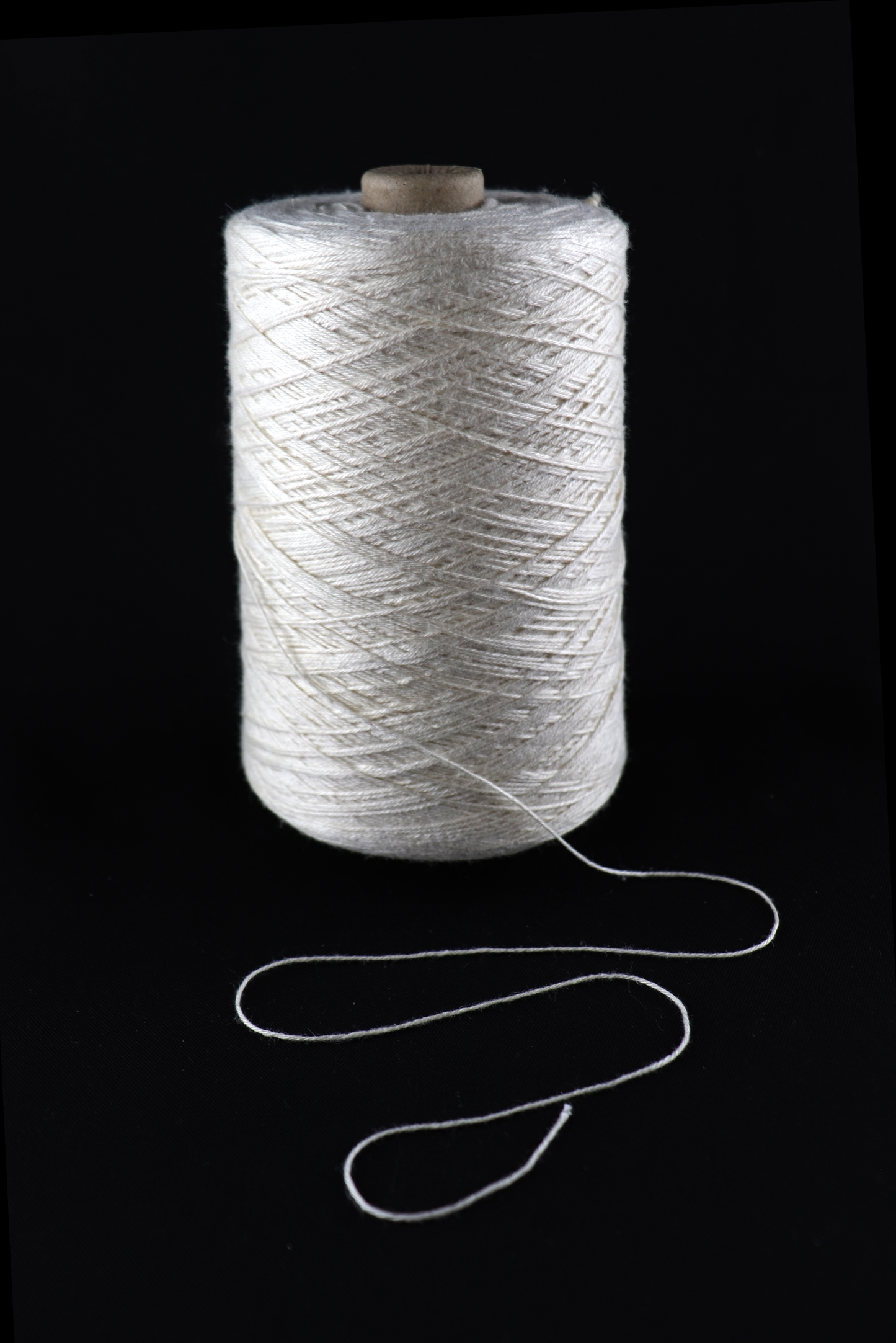 cone of white yarn