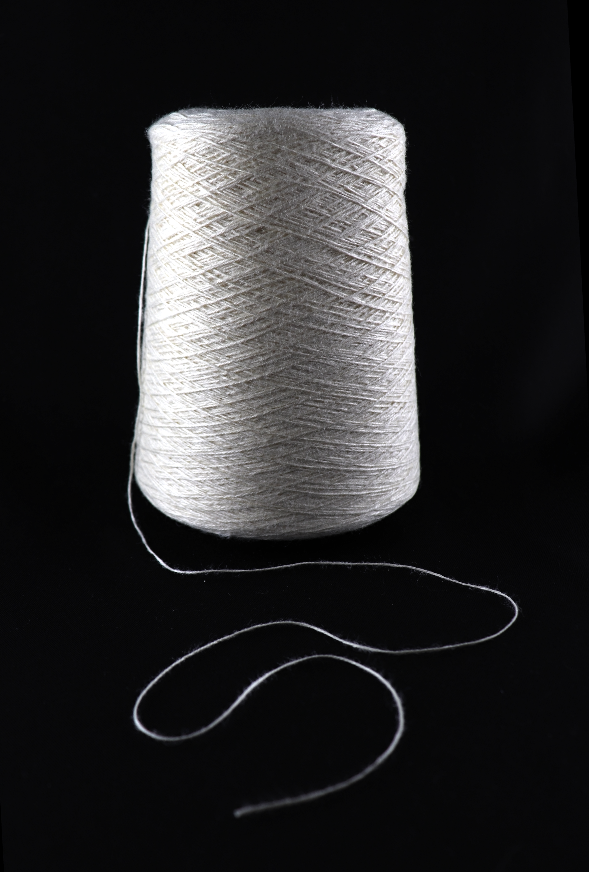 cone of white yarn