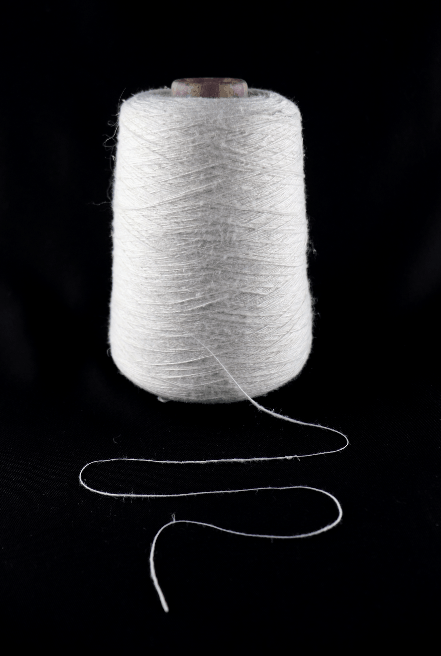cone of white yarn