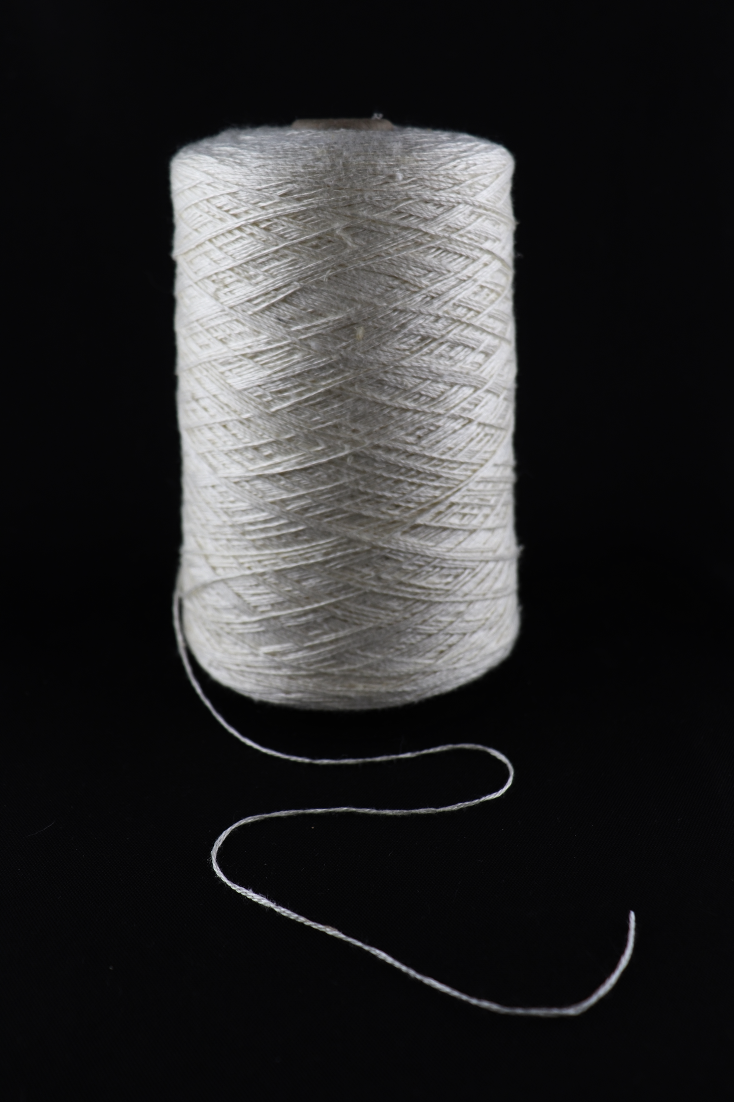 cone of white yarn
